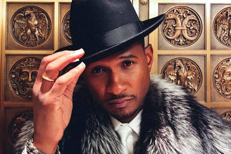 usher dans un clip portant un fedora